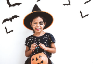 child wearing a witch costume